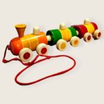 a colorful wooden train with wheels